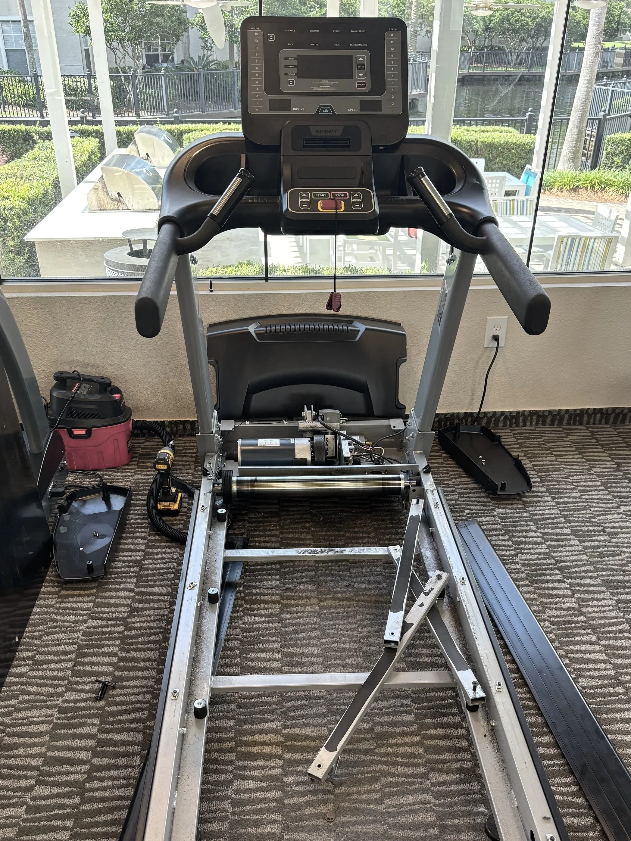 Treadmill disassembled for preventive maintenance and belt service in Jacksonville, FL